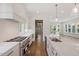 Gourmet kitchen featuring stainless appliances, white countertops, island with sink, and hardwood floors at 3302.5 Hall Pl, Raleigh, NC 27607