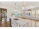 Bright kitchen featuring island with sink and view into adjacent living room at 3302.5 Hall Pl, Raleigh, NC 27607