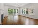 Spacious living room filled with natural light, featuring dark hardwood floors and a sliding glass door to the porch at 3302.5 Hall Pl, Raleigh, NC 27607