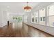 Spacious living room with hardwood floors, a fireplace, and large windows offering plenty of natural light at 3302.5 Hall Pl, Raleigh, NC 27607