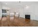 Spacious living area boasts hardwood floors, a fireplace, built-in cabinets, and views into the kitchen at 3302.5 Hall Pl, Raleigh, NC 27607