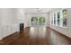 Inviting living room featuring hardwood floors, a fireplace, built-in cabinets, and large windows at 3302.5 Hall Pl, Raleigh, NC 27607