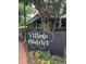Village District sign with surrounding greenery and a shopping area at 3302.5 Hall Pl, Raleigh, NC 27607