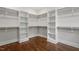 Well-organized walk-in closet with custom shelving and dark hardwood floors for optimal storage at 3302.5 Hall Pl, Raleigh, NC 27607