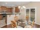 An open kitchen with stainless appliances, dark counters, and a breakfast nook with a glass table at 3417 Cardinal Lake Dr, Durham, NC 27704