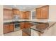 Spacious kitchen featuring stainless steel appliances, dark counters, and brown cabinets at 3417 Cardinal Lake Dr, Durham, NC 27704