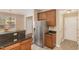 A kitchen featuring stainless steel appliances, granite counters, and brown cabinets at 3417 Cardinal Lake Dr, Durham, NC 27704