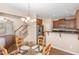 Open kitchen with stainless appliances, granite counters, and an eat-in dining space at 3417 Cardinal Lake Dr, Durham, NC 27704