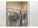Laundry room with a front-load washer and dryer, and wire shelving at 3417 Cardinal Lake Dr, Durham, NC 27704
