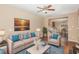 Inviting living room with hardwood floors, a comfortable couch, and natural light at 3417 Cardinal Lake Dr, Durham, NC 27704