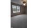 Large bedroom with window and neutral colored carpet at 788 Roberts Rd, Sanford, NC 27332