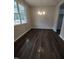 Simple dining room with dark flooring and a chandelier at 788 Roberts Rd, Sanford, NC 27332