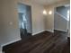 Dining room with dark flooring, chandelier, and view into kitchen at 788 Roberts Rd, Sanford, NC 27332