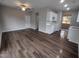 Open concept dining and kitchen area with dark flooring, white cabinets at 788 Roberts Rd, Sanford, NC 27332