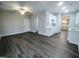 Open concept dining and kitchen area with dark flooring, white cabinets at 788 Roberts Rd, Sanford, NC 27332