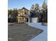 Two-story house with gray siding, white garage doors, and a curved driveway at 788 Roberts Rd, Sanford, NC 27332