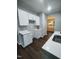 Modern kitchen with white cabinets, quartz countertops, and dark laminate floors at 788 Roberts Rd, Sanford, NC 27332