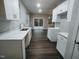 Modern kitchen with white cabinets and access to backyard at 788 Roberts Rd, Sanford, NC 27332