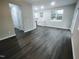 Living room with dark flooring and access to kitchen and hallway at 788 Roberts Rd, Sanford, NC 27332