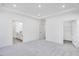 Spacious bedroom with neutral carpet, recessed lighting, and en suite bathroom with walk-in closet at 800 Heathered Farm Way, Apex, NC 27523