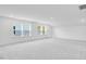 Spacious carpeted bedroom boasting large windows providing ample natural light and neutral paint at 800 Heathered Farm Way, Apex, NC 27523