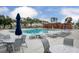 Community pool area with tables, lounge chairs, and umbrellas for relaxation and recreation at 800 Heathered Farm Way, Apex, NC 27523