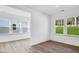 Bright living room featuring laminate floors, natural light, and white trim at 800 Heathered Farm Way, Apex, NC 27523