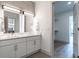 Modern bathroom features a double sink vanity, stylish mirrors and lighting, with a view into the walk-in closet at 120 Mosaic Blvd # 307, Pittsboro, NC 27312