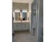 Modern bathroom boasts a double vanity, sleek mirrors, and contemporary decor, with a view to the spacious walk-in closet at 120 Mosaic Blvd # 307, Pittsboro, NC 27312