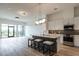 Modern kitchen with white cabinets, stainless steel appliances, gray backsplash, and island with seating at 120 Mosaic Blvd # 307, Pittsboro, NC 27312