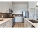 Modern kitchen featuring stainless steel appliances, sleek countertops, and stylish gray backsplash at 120 Mosaic Blvd # 307, Pittsboro, NC 27312