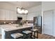 Modern kitchen with white cabinets, gray backsplash, stainless steel appliances, and quartz countertop at 120 Mosaic Blvd # 307, Pittsboro, NC 27312