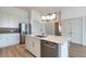 The modern kitchen island with stainless steel dishwasher, faucet, and cabinets at 120 Mosaic Blvd # 307, Pittsboro, NC 27312