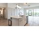 Bright, modern kitchen features a quartz island, stainless steel appliances, and hardwood floors at 120 Mosaic Blvd # 307, Pittsboro, NC 27312
