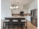 Contemporary kitchen with sleek white cabinets, stainless steel appliances, and island with seating at 120 Mosaic Blvd # 307, Pittsboro, NC 27312