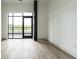 Living room with door to the balcony and view at 120 Mosaic Blvd # 307, Pittsboro, NC 27312