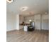 Open-concept layout connecting the living room and kitchen with modern lighting fixtures at 120 Mosaic Blvd # 307, Pittsboro, NC 27312
