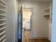 Bright walk-in closet boasts custom shelving and flows into a modern bathroom, combining convenience with luxurious design at 120 Mosaic Blvd # 307, Pittsboro, NC 27312