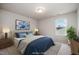 Stylishly staged bedroom with a serene blue color palette, lamps, and eye-catching artwork at 2062 Alderman Way, Creedmoor, NC 27522