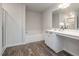 This main bathroom has a bathtub, shower, and vanity with modern finishes at 2062 Alderman Way, Creedmoor, NC 27522