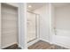 The main bathroom offers a glass shower, tub, and spacious walk-in closet at 2062 Alderman Way, Creedmoor, NC 27522