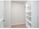Bright walk-in closet featuring custom white shelving for optimal storage and organization at 2062 Alderman Way, Creedmoor, NC 27522