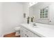 Bathroom featuring white fixtures, a large mirror, and ample counter space for convenience at 2169 Northcrest Dr, Elon, NC 27244