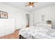 Bright bedroom with hardwood floors, ceiling fan, and Paris-themed bedding adding a touch of elegance at 2169 Northcrest Dr, Elon, NC 27244