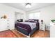 Bedroom with mirrored closet, updated lighting, and laminate flooring at 2169 Northcrest Dr, Elon, NC 27244