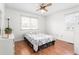 Cozy bedroom with a ceiling fan, hardwood floors, and two windows offering ample natural light at 2169 Northcrest Dr, Elon, NC 27244