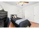 Bedroom with natural light from its window, hardwood floors, and ceiling fan, creating a peaceful space at 2169 Northcrest Dr, Elon, NC 27244