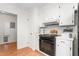 Charming kitchen with white cabinets and black appliances and neutral backsplash at 2169 Northcrest Dr, Elon, NC 27244