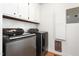 Laundry room with side-by-side gray front-loading washer and dryer at 2169 Northcrest Dr, Elon, NC 27244