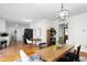 Open-concept living room features a modern chandelier and a table with seating at 2169 Northcrest Dr, Elon, NC 27244